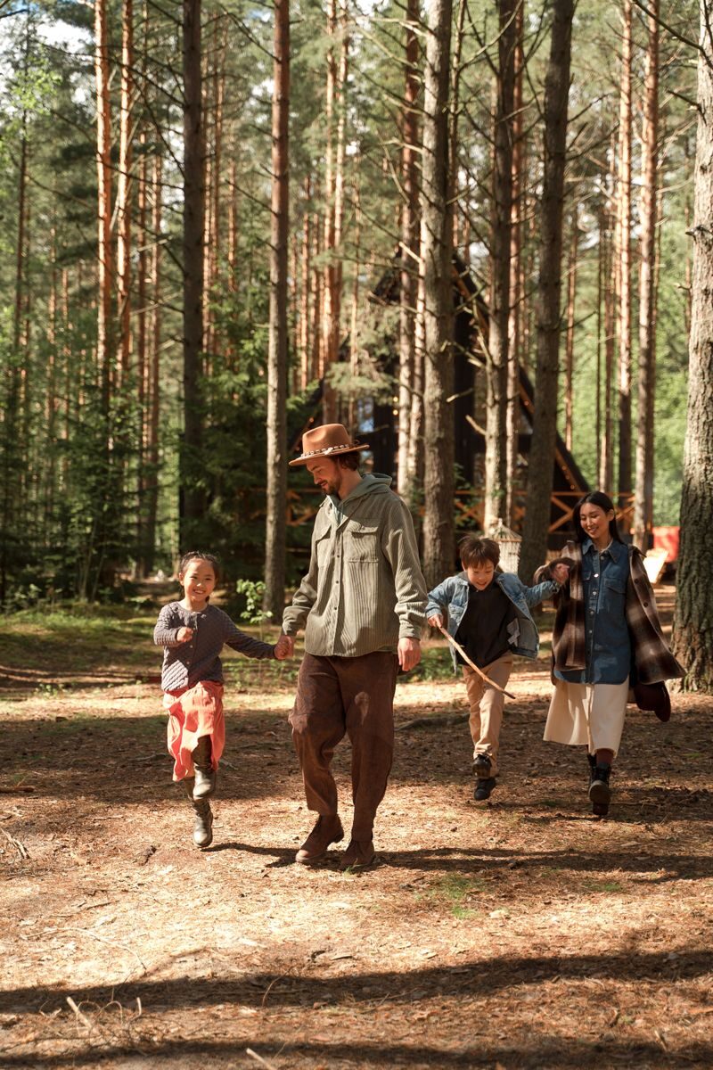 A family enjoys a day of hiking and exploring in a dense forest, promoting outdoor fun and bonding.