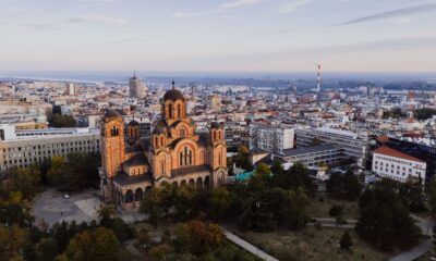 Captivating aerial view of Belgrade cityscape with St. Mark's Church at sunset.