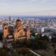 Captivating aerial view of Belgrade cityscape with St. Mark's Church at sunset.
