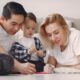 A family enjoys a fun and creative bonding session with drawing activities indoors.