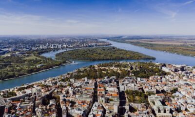 Aerial view showcasing the cityscape of Belgrade, Serbia with the Danube River winding through the landscape.