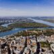 Aerial view showcasing the cityscape of Belgrade, Serbia with the Danube River winding through the landscape.