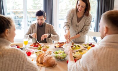 Four friends sharing a delightful meal indoors, highlighting friendship and togetherness.