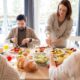 Four friends sharing a delightful meal indoors, highlighting friendship and togetherness.