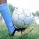 Close-up of a soccer player controlling the ball during a game in Kuttanad.