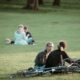 Two friends enjoy a sunny day in the park with their bicycles, reflecting leisure and relaxation.