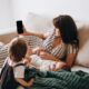 A mother and her children enjoy leisure time on the sofa, highlighting family togetherness and relaxation.