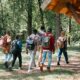 A diverse group of friends hiking together on a sunny day in the forest, capturing unity and adventure.
