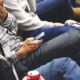 People sitting at a conference casually checking smartphones, communicating and networking.