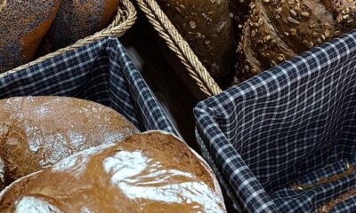 Assorted artisan breads in baskets, showcasing rustic styles and textures.