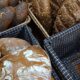 Assorted artisan breads in baskets, showcasing rustic styles and textures.