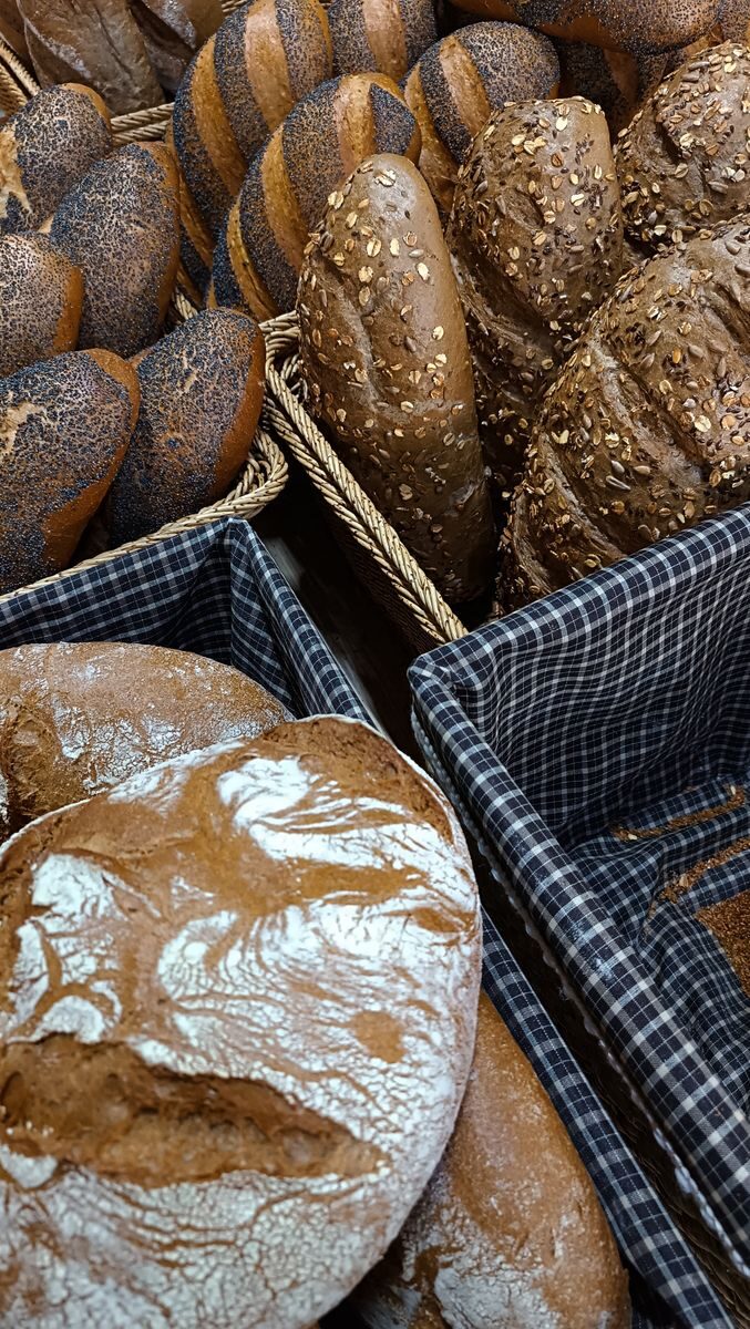 Assorted artisan breads in baskets, showcasing rustic styles and textures.