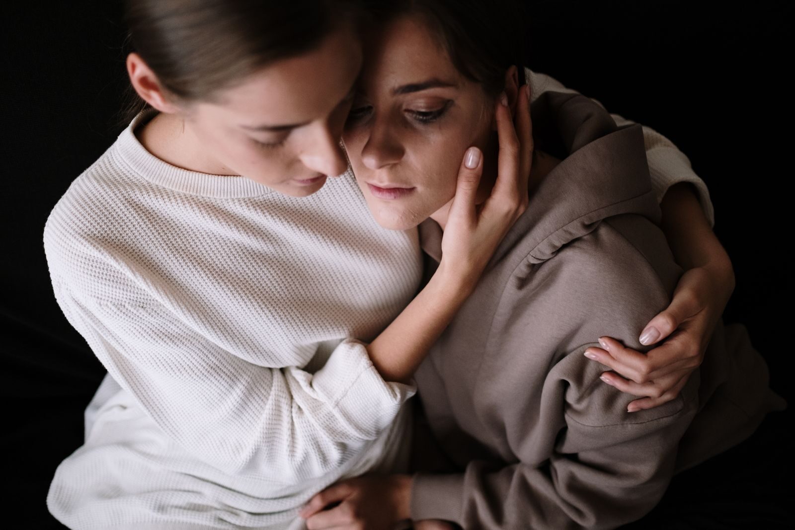 Two women embracing supportively, reflecting emotional bonding and comfort in difficult times.