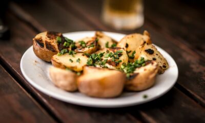 Delicious grilled potatoes garnished with fresh chives, perfect for a rustic meal.