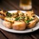 Delicious grilled potatoes garnished with fresh chives, perfect for a rustic meal.