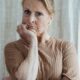 Portrait of a serious senior woman in a thoughtful pose indoors.