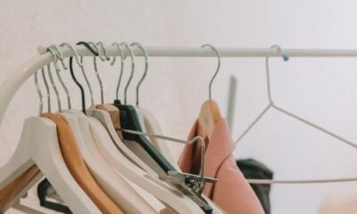 Elegant blazers hanging on a modern clothes rack indoors, perfect for fashion and retail themes.