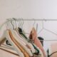 Elegant blazers hanging on a modern clothes rack indoors, perfect for fashion and retail themes.