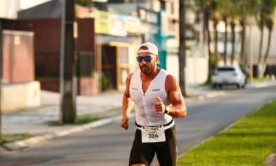 Male athlete in sportswear running on city street during a marathon.