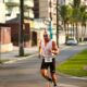 Male athlete in sportswear running on city street during a marathon.