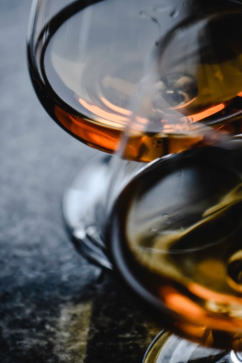Elegant close-up shot of whiskey glasses showcasing warm tones and reflections.