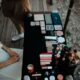 Top view of various makeup products on a table outdoors in Muğla, Türkiye.