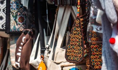 Colorful handmade bags and items displayed at a street shop in Kochi, India.