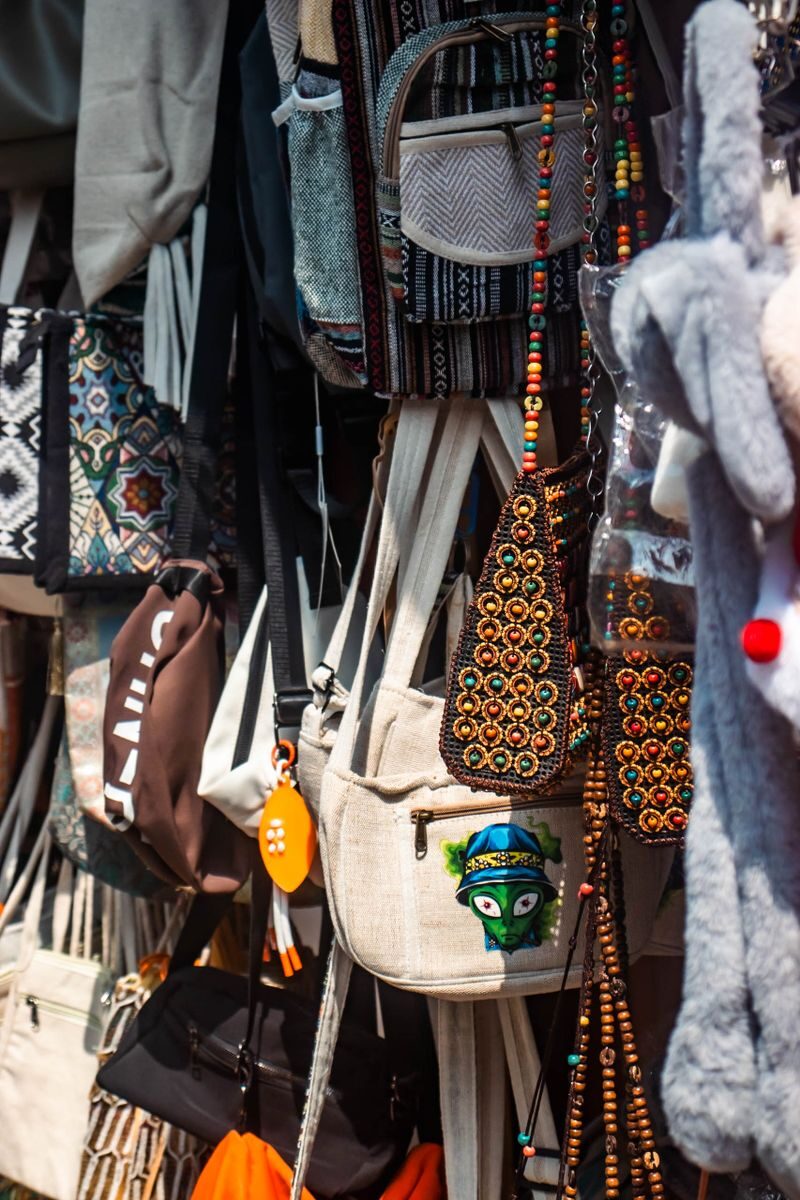 Colorful handmade bags and items displayed at a street shop in Kochi, India.