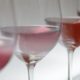 Close-up of various wine glasses filled with rosé in soft lighting, perfect for wine tasting events.