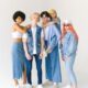 Full body group of smiling teenage friends in jeans clothes standing against white background and looking at camera