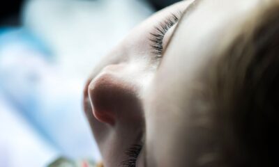 Intimate close-up photo of a child's face in soft light, focusing on serene eyelashes.