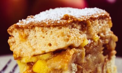 Scrumptious slice of apple cake dusted with powdered sugar, perfect for dessert lovers.