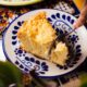 A delectable Mexican corn cake slice served on a traditional pattern plate, showcasing vibrant colors and inviting textures.