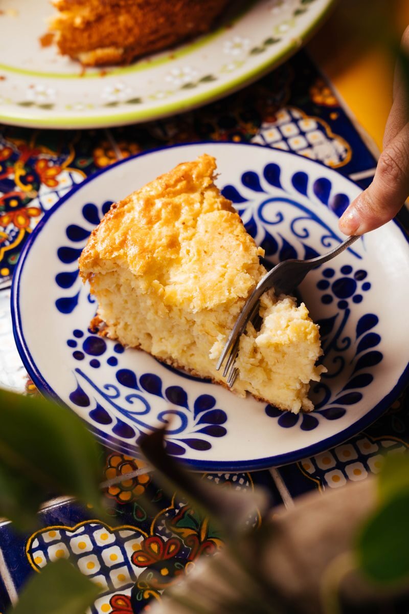 A delectable Mexican corn cake slice served on a traditional pattern plate, showcasing vibrant colors and inviting textures.