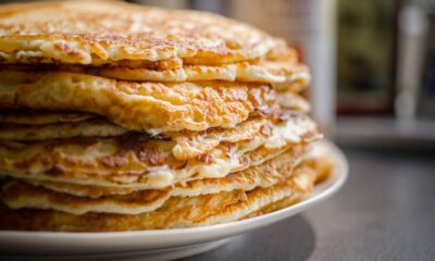Close-up of delicious homemade pancakes stacked high on a plate, perfect for breakfast.