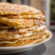 Close-up of delicious homemade pancakes stacked high on a plate, perfect for breakfast.